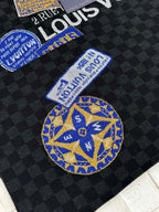 Louis Vuitton knit polo with blue-and-yellow embroidered emblem patches