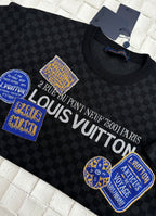 Louis Vuitton checkered knit polo with large logo text and blue patches