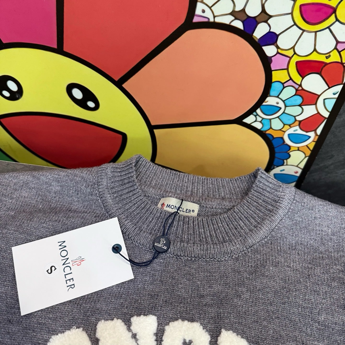 Light gray crewneck sweater neckline with Moncler tag and ribbed knit collar