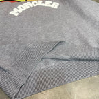 Light gray sweater ribbed cuffs and knit hem detail