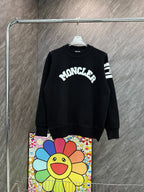 Black crewneck long-sleeve sweater with MONCLER graphic and striped sleeve detail