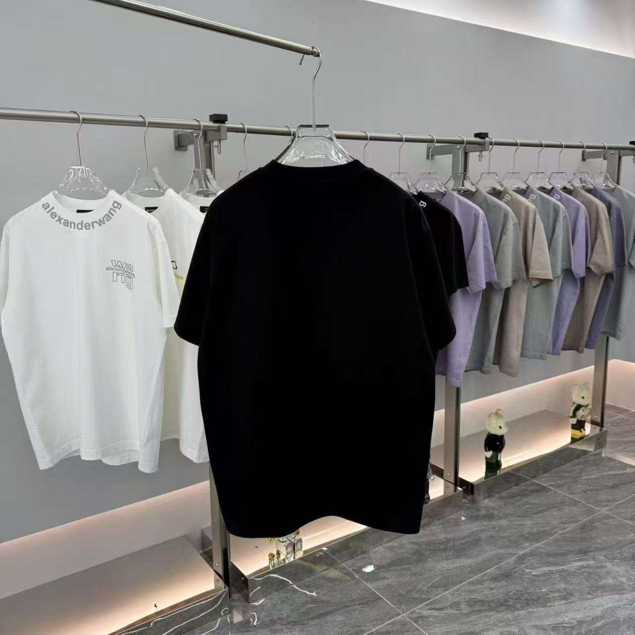 Prada short-sleeve T-shirt, black, front view on a clothing rack