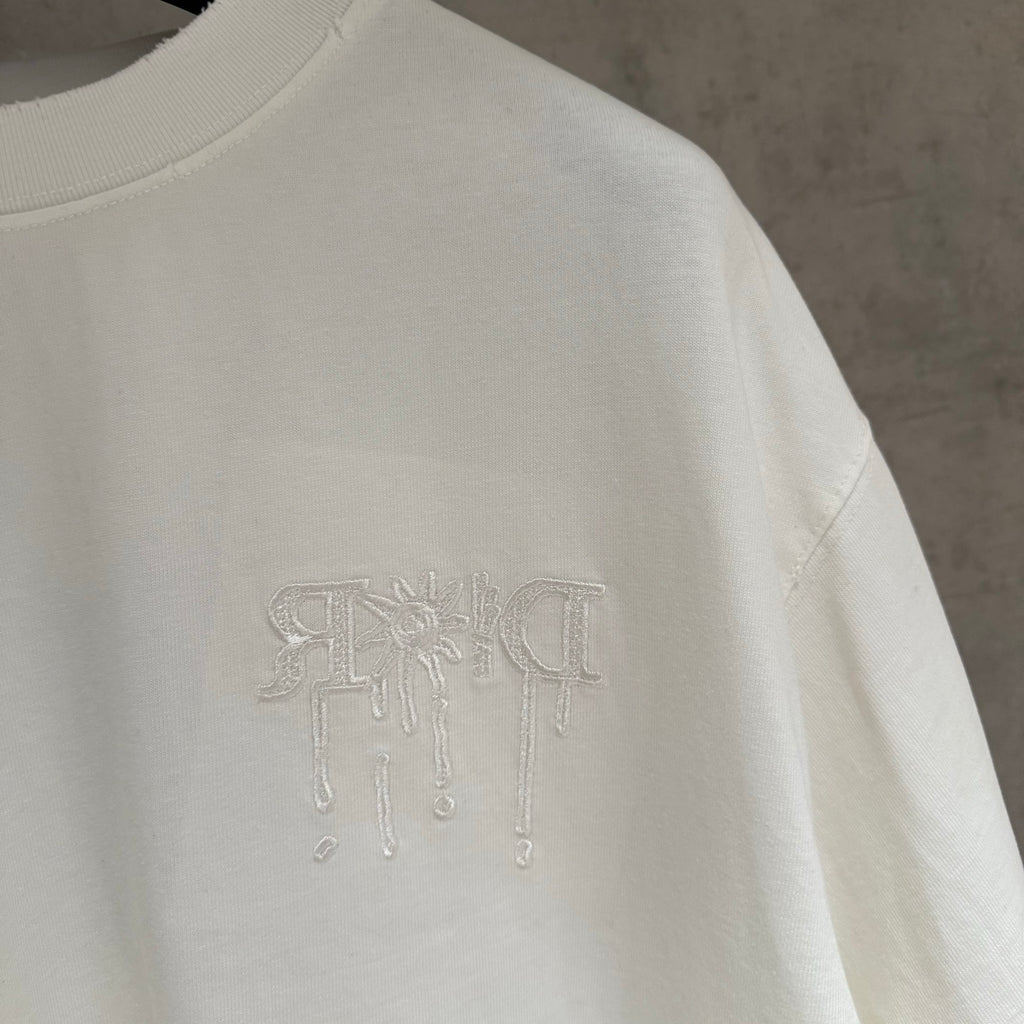 White Dior short-sleeve T-shirt side close-up with embossed logo