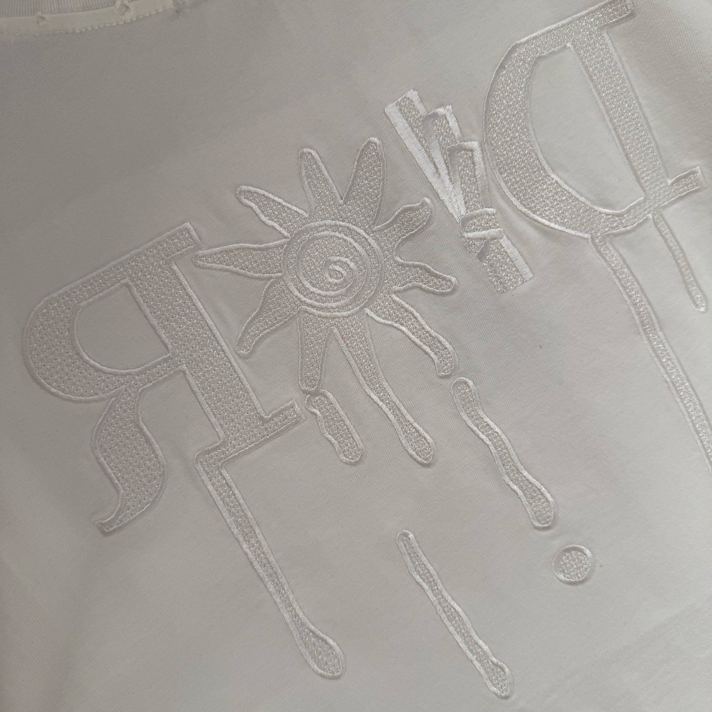 White Dior T-shirt graphic logo embossed across chest