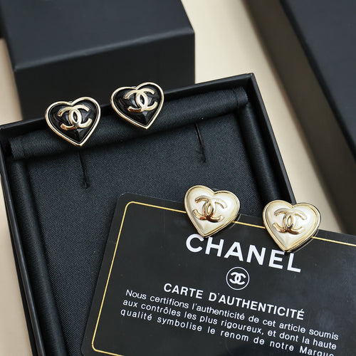 Heart-shaped Chanel stud earrings in box, gold-tone with black and white accents