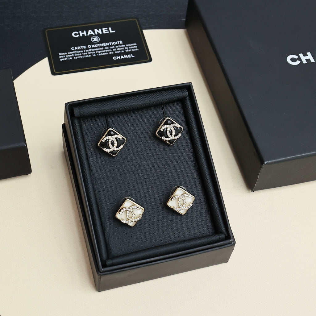 Set of square logo stud earrings arranged in a black jewelry box with certificate cards