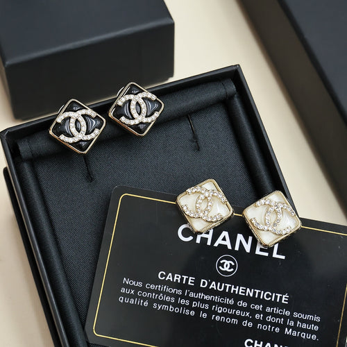Square logo stud earrings in black and gold tones, with sparkling stones in gift box