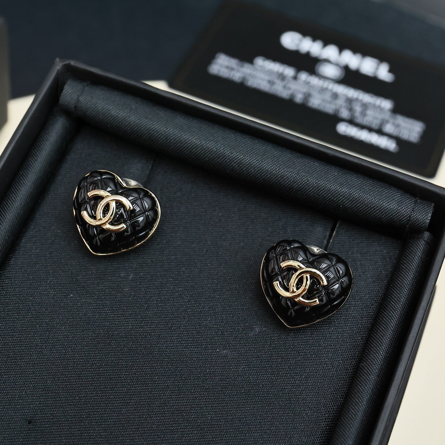 Chanel heart stud earrings: black enamel with gold CC logo, in box