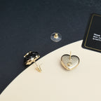 Chanel heart stud earrings close-up: textured gold-toned backs and posts