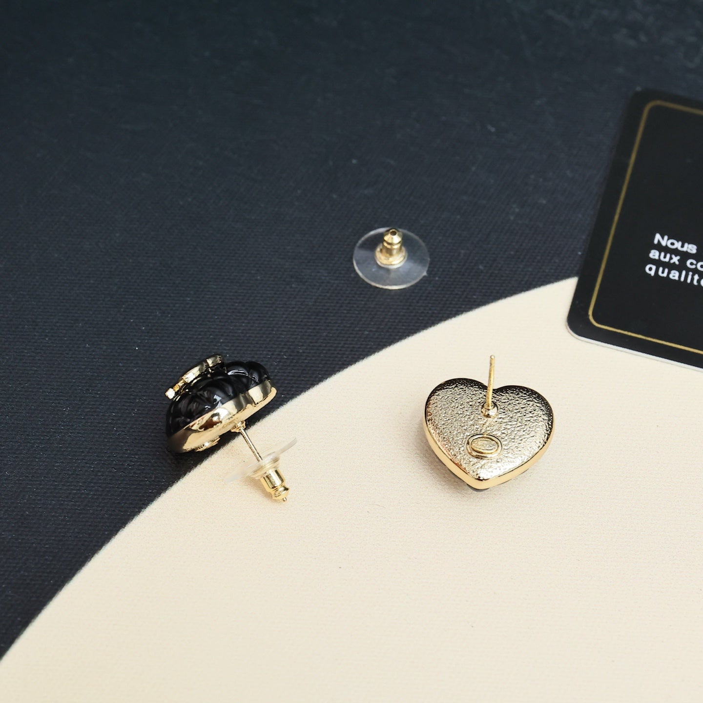 Chanel heart stud earrings close-up: textured gold-toned backs and posts