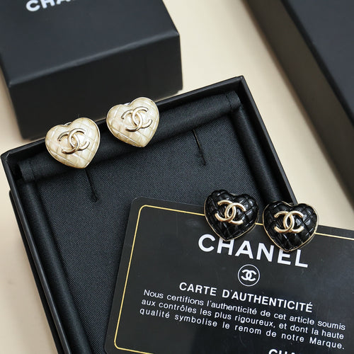 Chanel heart stud earrings: white and black enamel with gold CC logos, in box