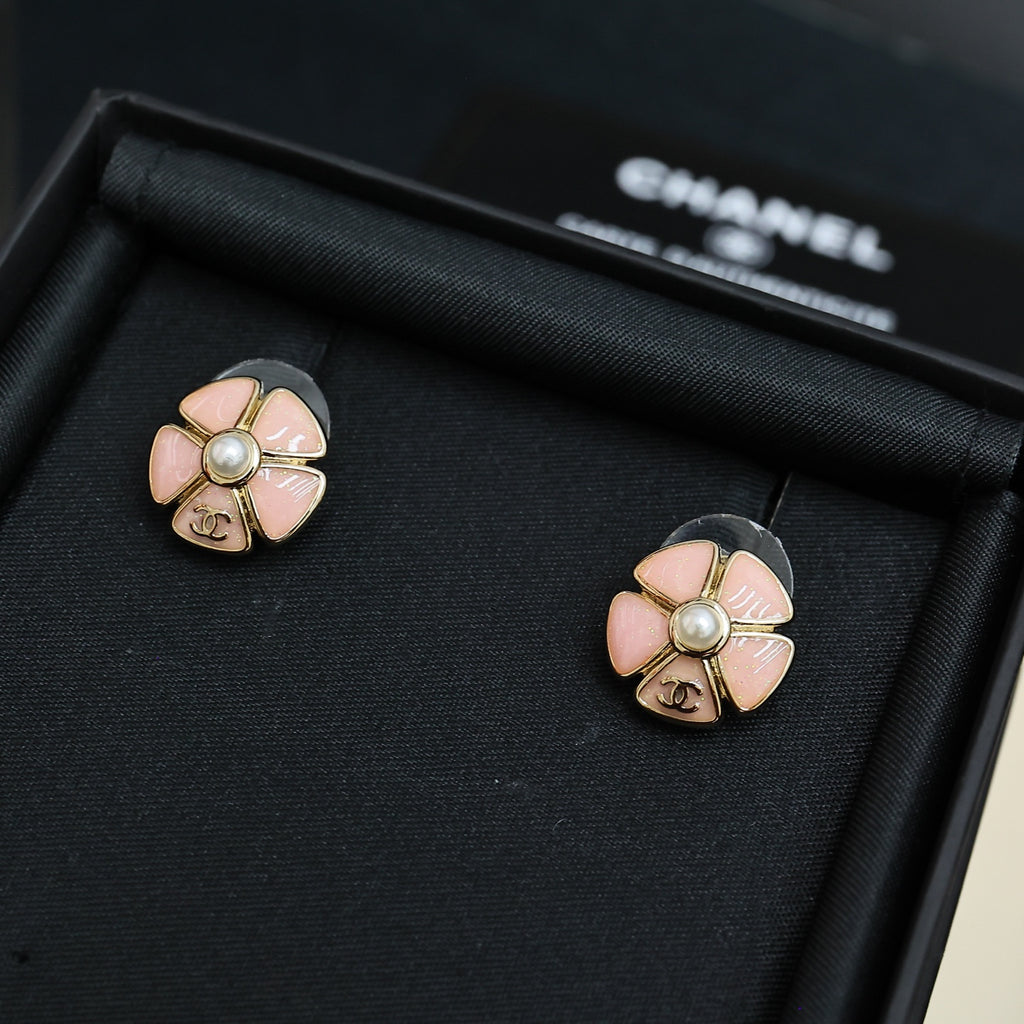Chanel floral stud earrings with pale pink petals and pearl, silver-tone flower detail