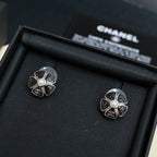 Chanel floral stud earrings with pearl, silver-tone filigree flower with dark outlines