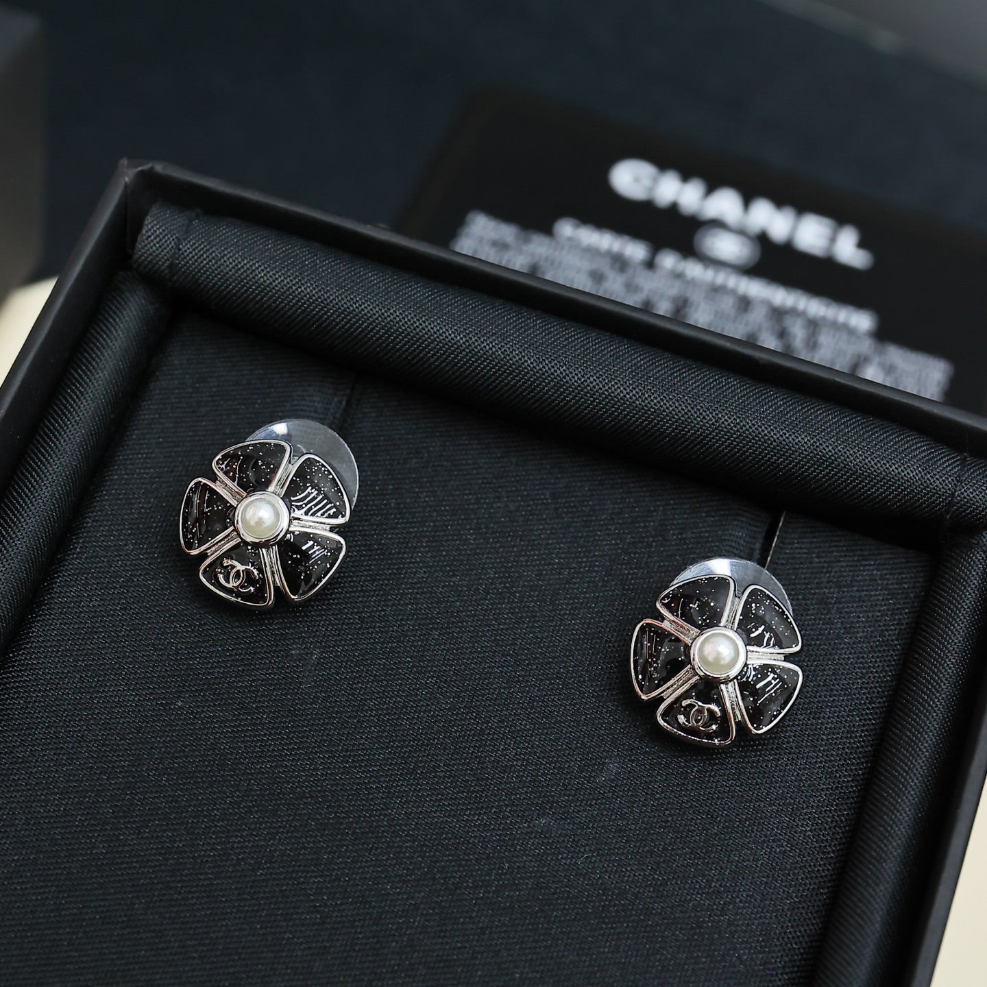 Chanel floral stud earrings with pearl, silver-tone filigree flower with dark outlines