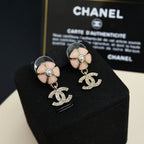 Chanel flower stud earrings with pearl center and dangling CC logo charms in silver tone