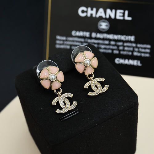 Chanel flower stud earrings with pearl center and dangling CC logo charms in silver tone