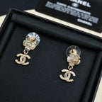 Chanel stud earrings with round disc backs, dangling CC logo charms, light gold tone