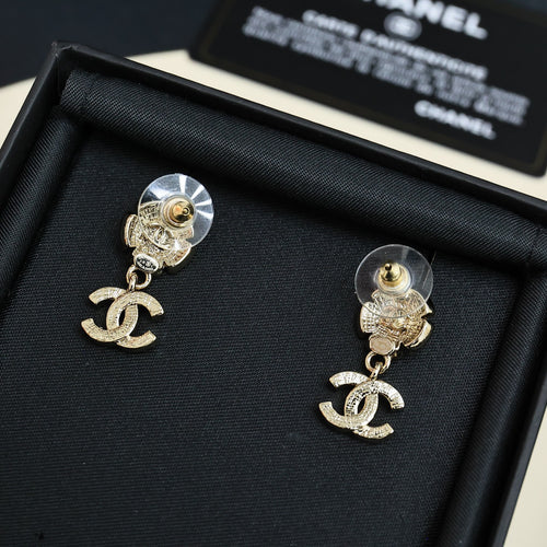Chanel stud earrings with round disc backs, dangling CC logo charms, light gold tone