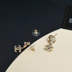 Chanel earrings with pearl flower studs and dangling CC logo charms in gold and silver tones