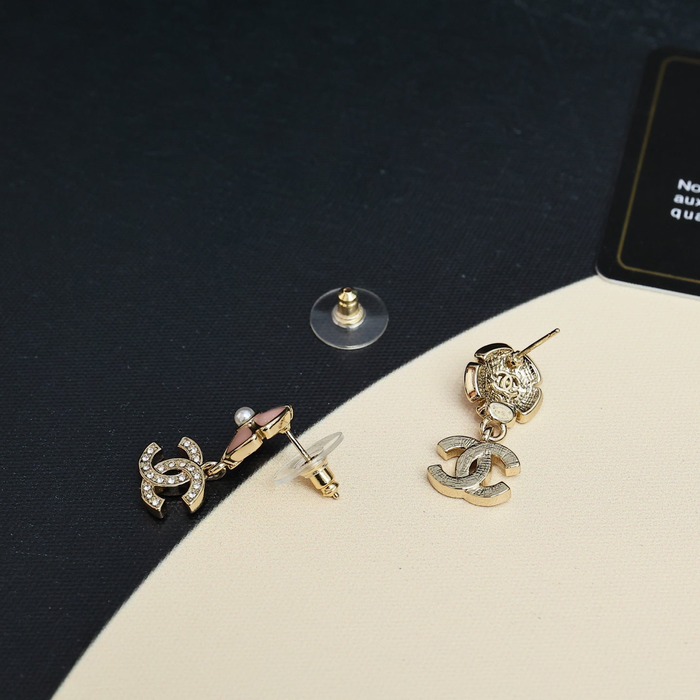 Chanel earrings with pearl flower studs and dangling CC logo charms in gold and silver tones