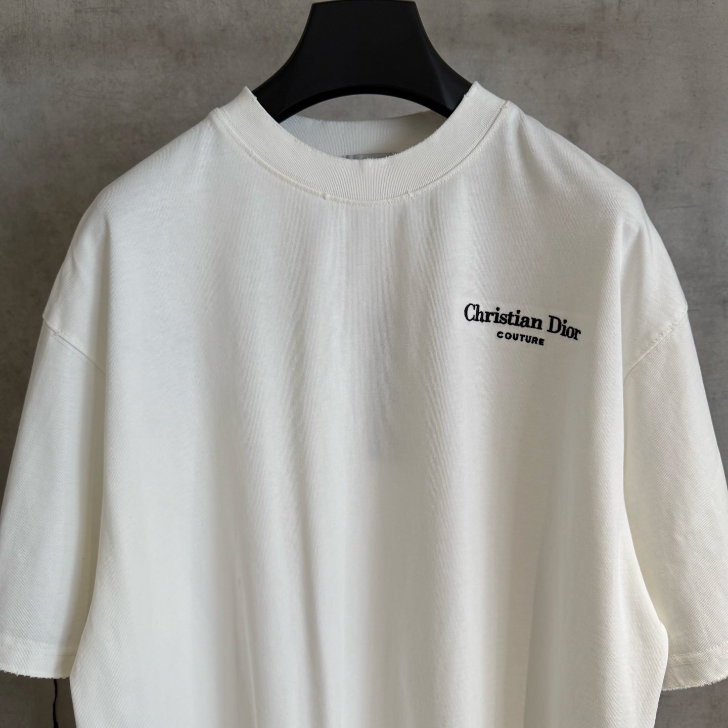 White Christian Dior T-shirt with small “Christian Dior Couture” logo at chest
