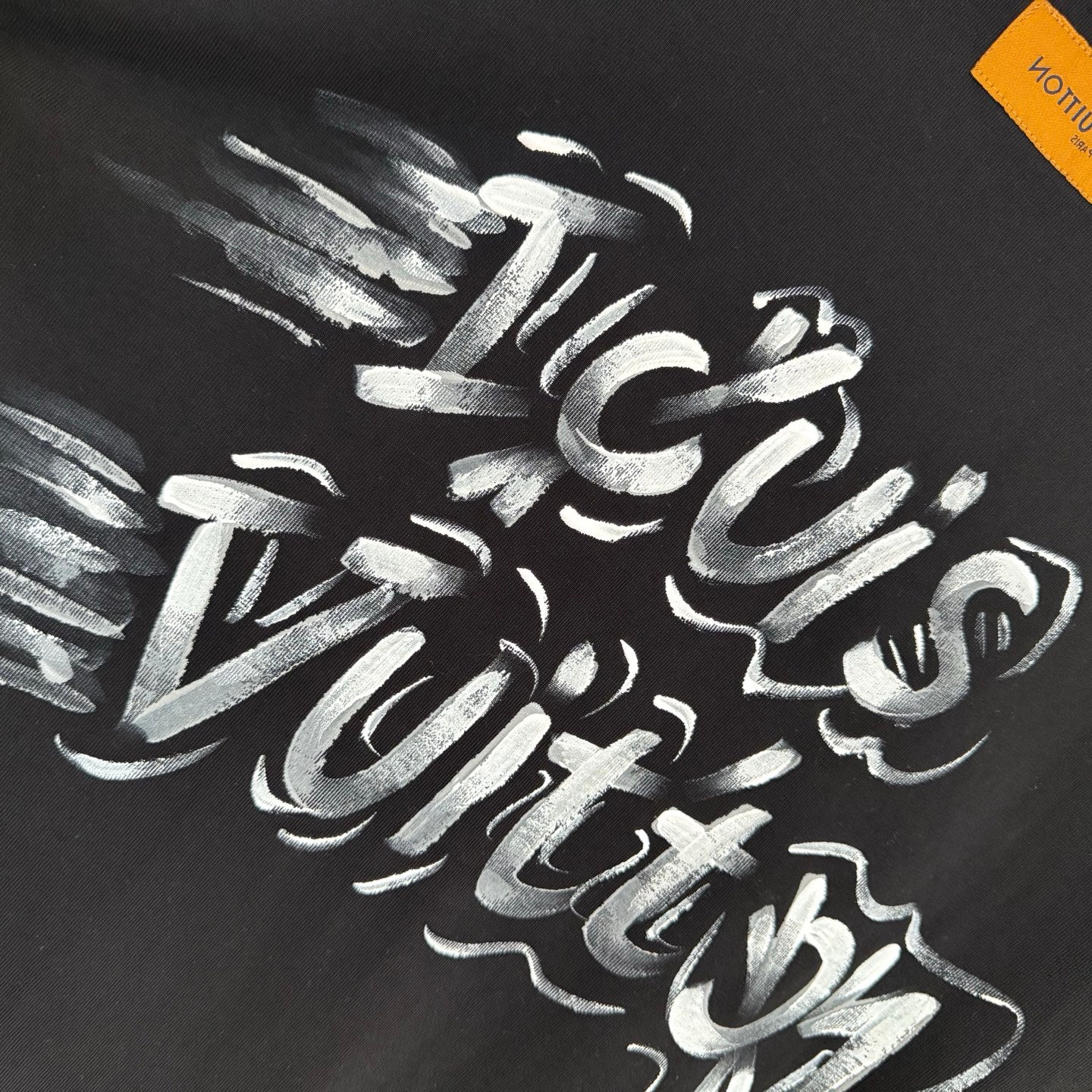 Louis Vuitton black T-shirt with white graffiti-style logo lettering detail