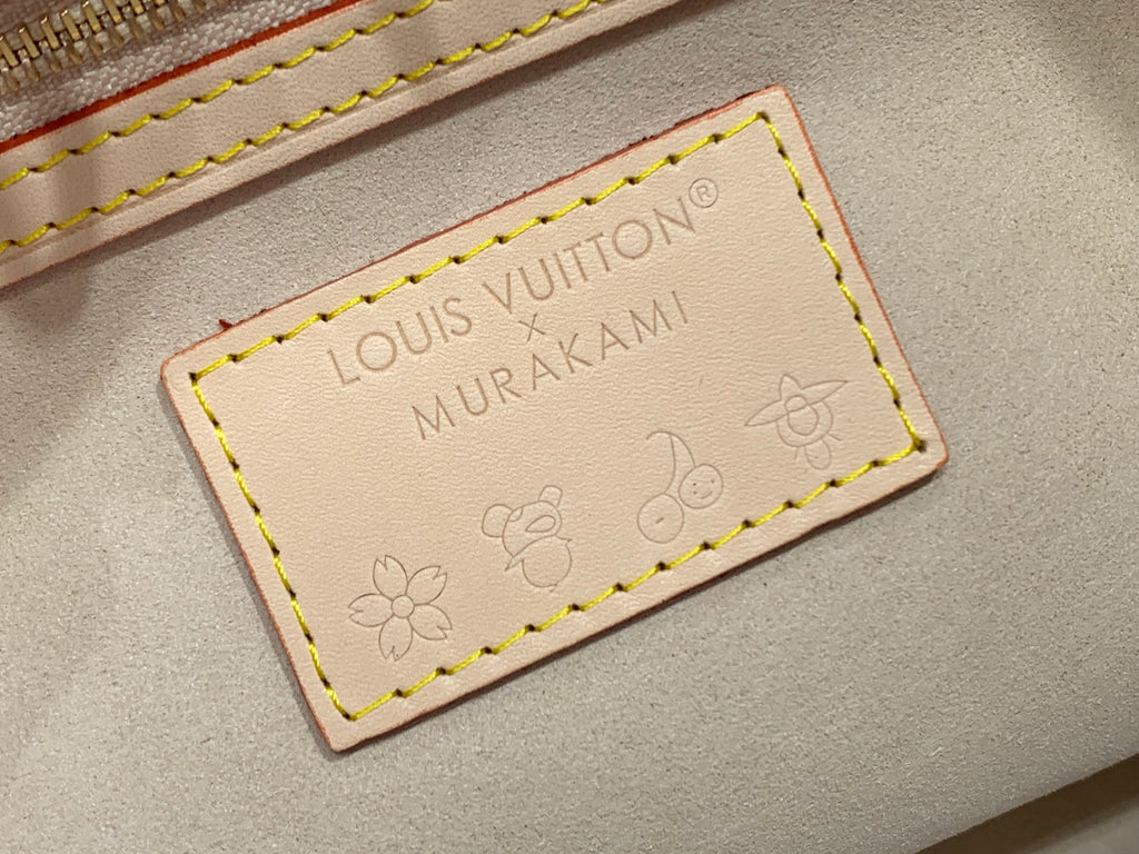 Beige leather logo label reading LOUIS VUITTON and MURAKAMI with floral design