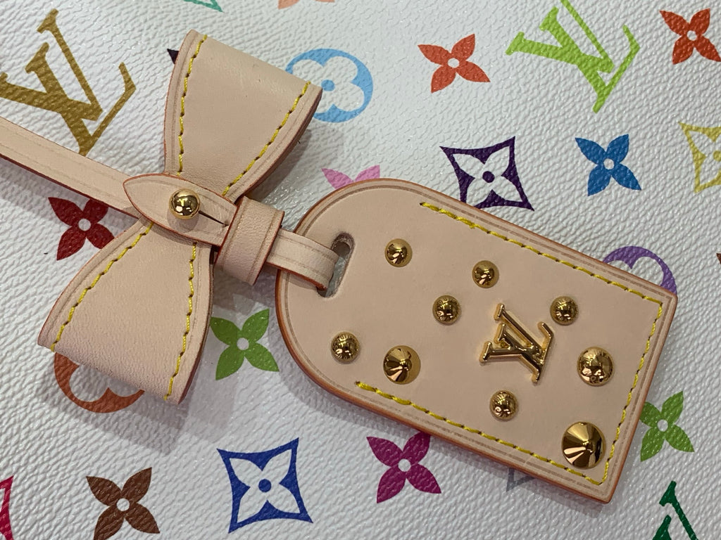 Beige leather bag strap charm with gold clasp and multicolor monogram trim