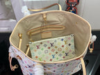 Designer tote bag open with multicolor monogram interior, inner zip pocket and straps