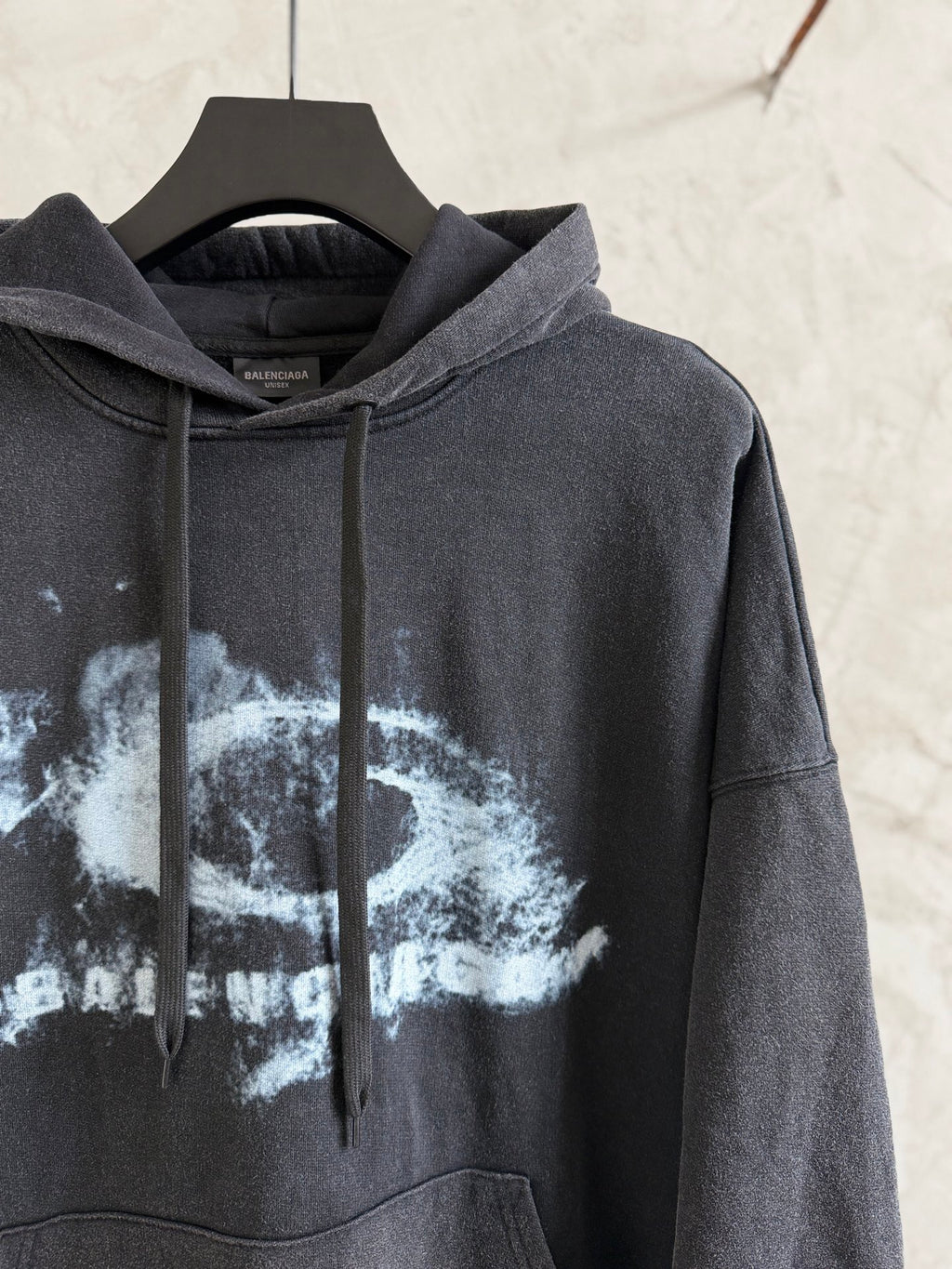 Dark gray Balenciaga hoodie with hood and front pocket; large white graphic print