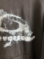 White graphic text on dark gray hoodie, close-up view