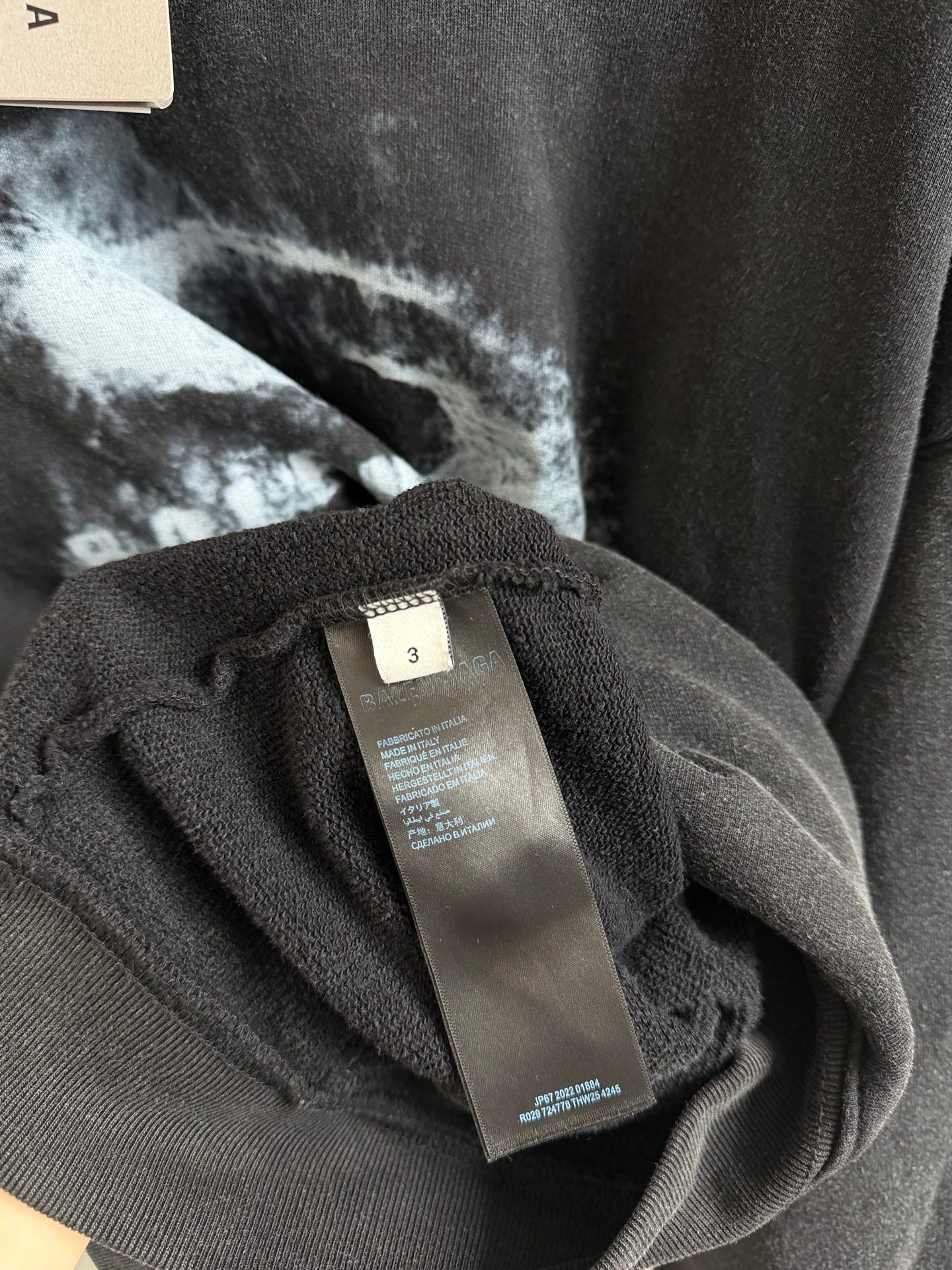 Hoodie care label on interior tag attached with Balenciaga branding