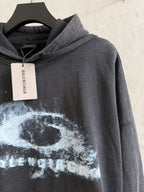 Balenciaga hoodie with hood and white graphic print; hangtag visible at neckline