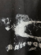Balenciaga short-sleeve T-shirt close-up of white distressed graphic on dark fabric