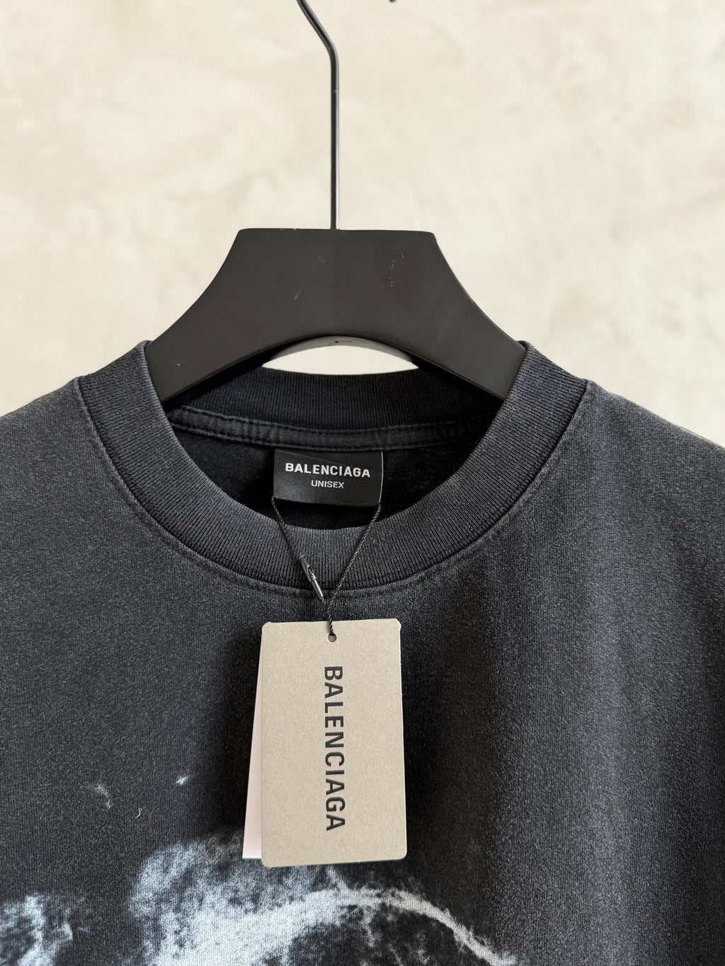 Balenciaga T-shirt collar with white hang tag, dark gray crewneck, short sleeves.