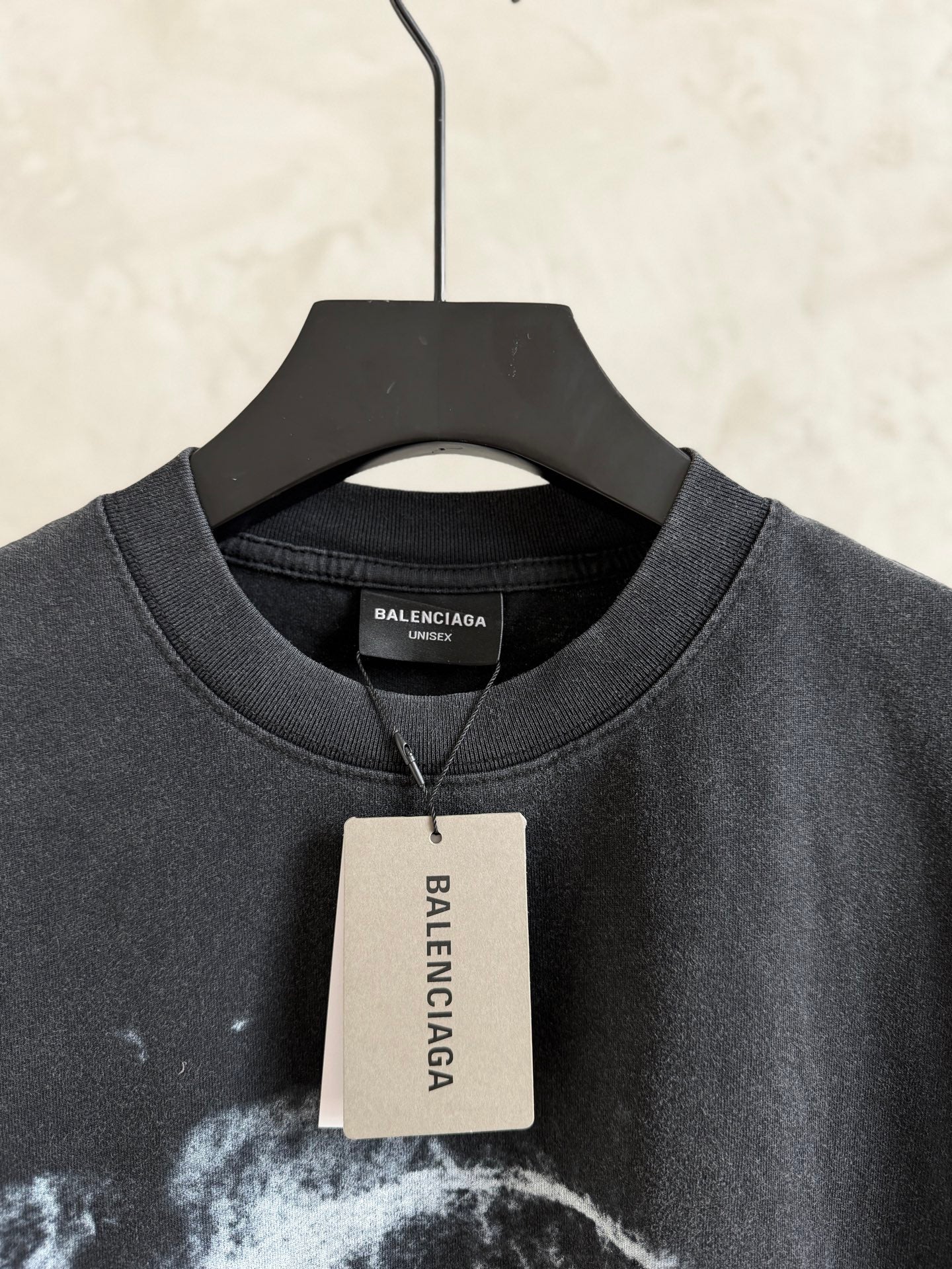 Balenciaga T-shirt collar with white hang tag, dark gray crewneck, short sleeves.
