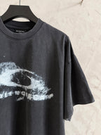 Balenciaga T-shirt angled front view with white graphic print on dark gray, short sleeves.