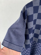 Navy blue short-sleeve shirt with check pattern across sleeves and hem panel detail.