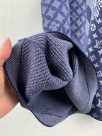 Navy blue short-sleeve shirt draped fabric detail with layered knit texture.