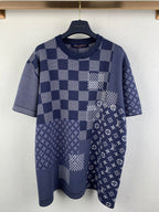 Navy blue short-sleeve shirt with check patchwork and small monogram motifs.