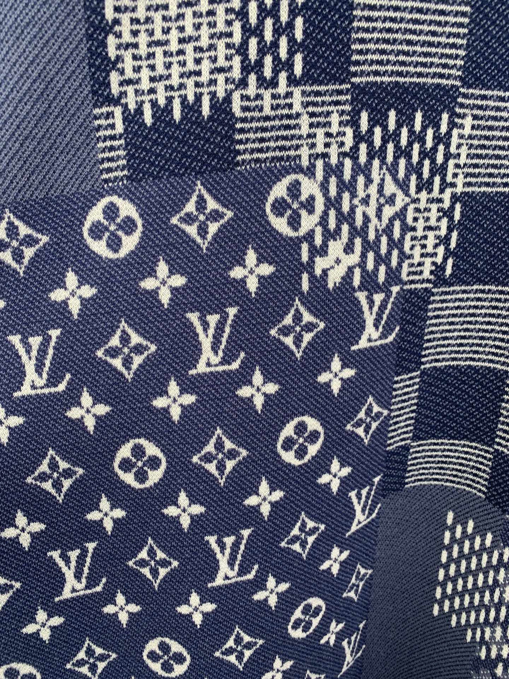 Navy short-sleeve fabric close-up with LV monogram symbols and grid checks