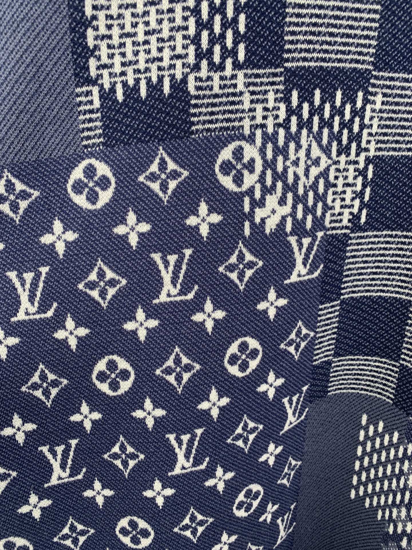 Navy short-sleeve fabric close-up with LV monogram symbols and grid checks