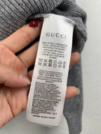 Gucci inner neck label on gray knit sweater, with care instructions
