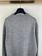 Gray knit sweater back with smooth textured fabric and ribbed neckline