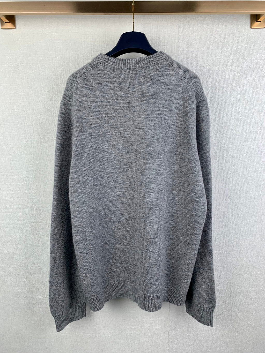 Gray knit crewneck sweater back view with ribbed hem and cuffs