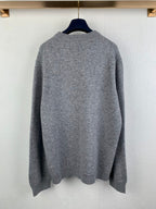 Gray knit crewneck sweater back view with ribbed hem and cuffs