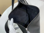 Louis Vuitton bag open with dark suede lining and zippered top closure