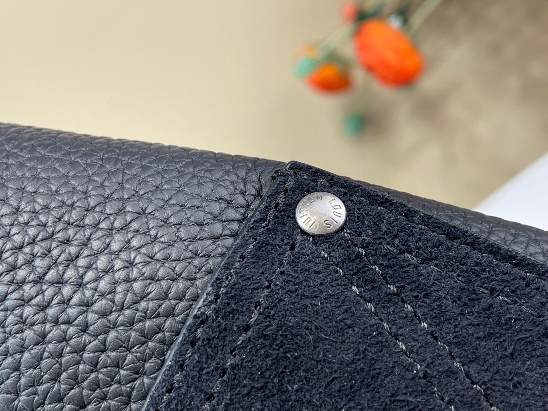 Louis Vuitton bag, dark textured leather with metal snap and top stitching detail