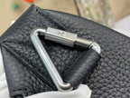 Louis Vuitton bag close-up of double silver D-ring hardware on dark leather