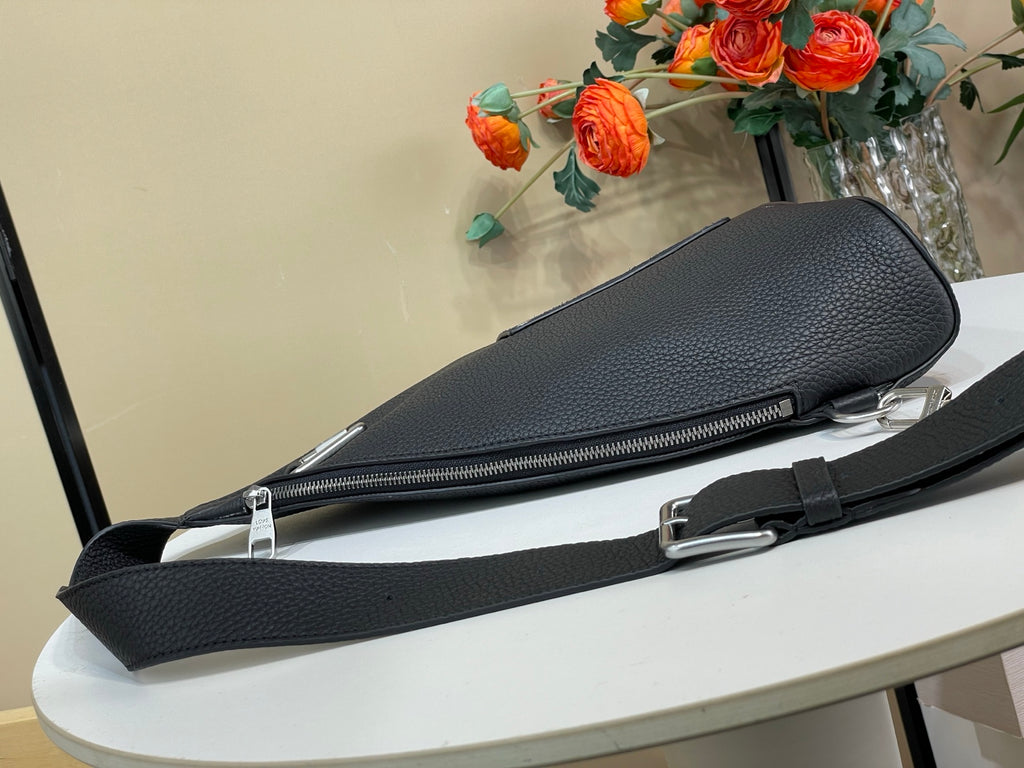 Louis Vuitton bag with long zip opening and dark textured leather strap hardware